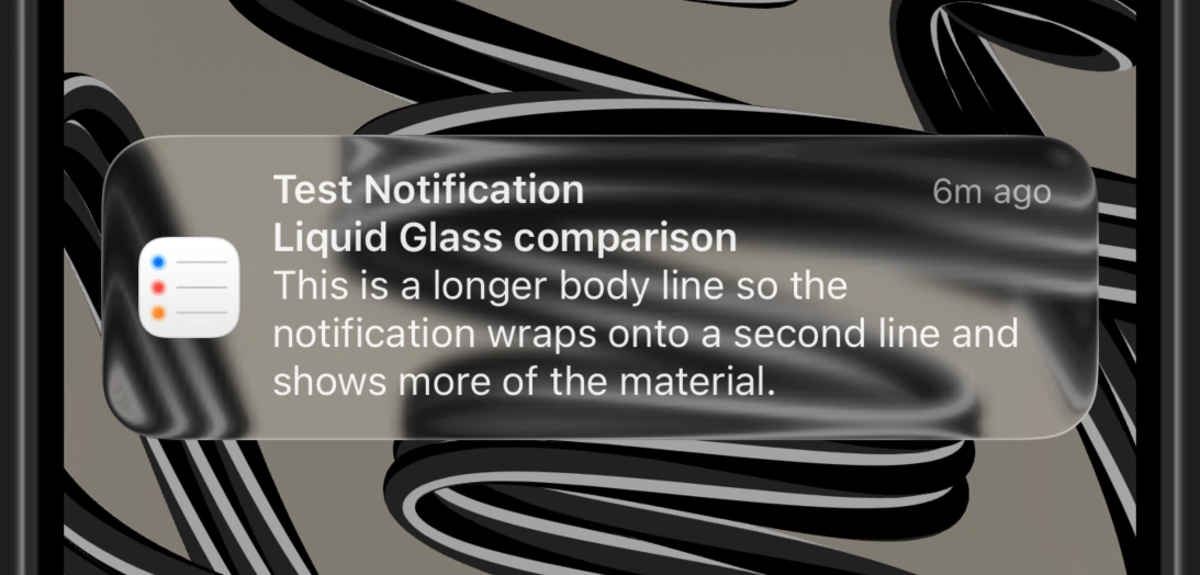 The same notification in iOS 26's dark mode using clear Liquid Glass.