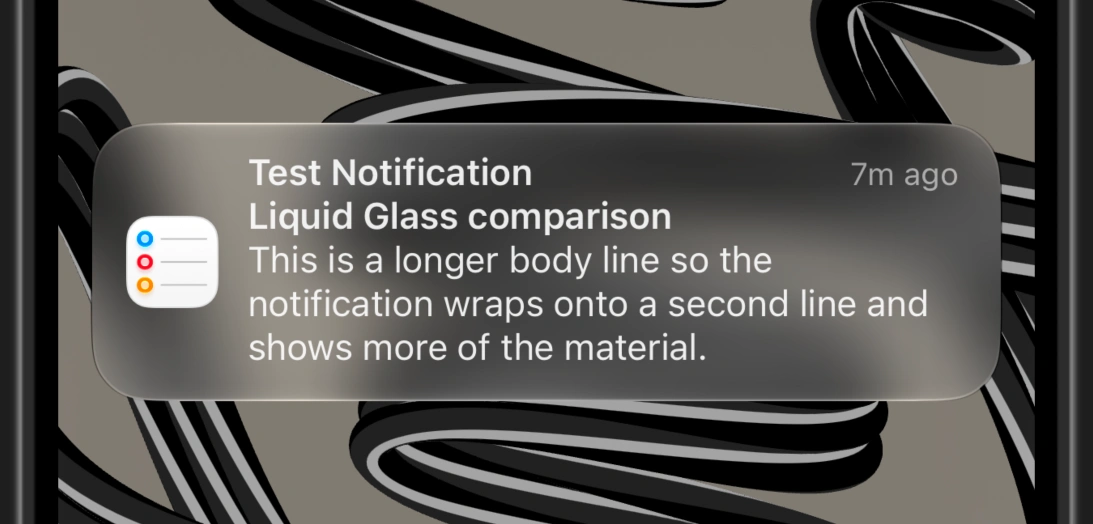 The same notification in iOS 27's dark mode using the tinted version of Liquid Glass.
